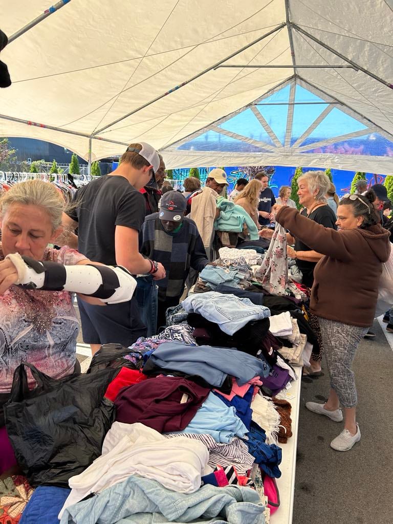 Donated clothing set out on tables for guests to choose from